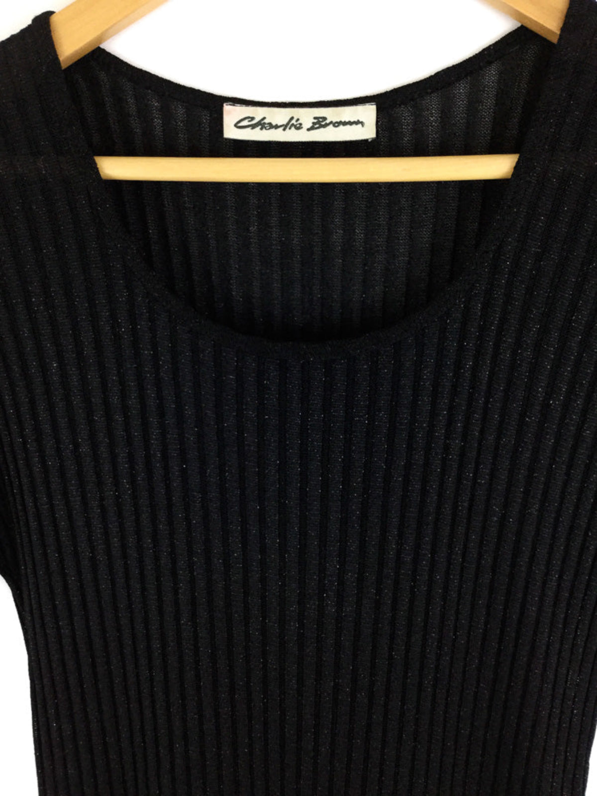 Black ribbed dress on a hanger with 'Charlie Brown' label.