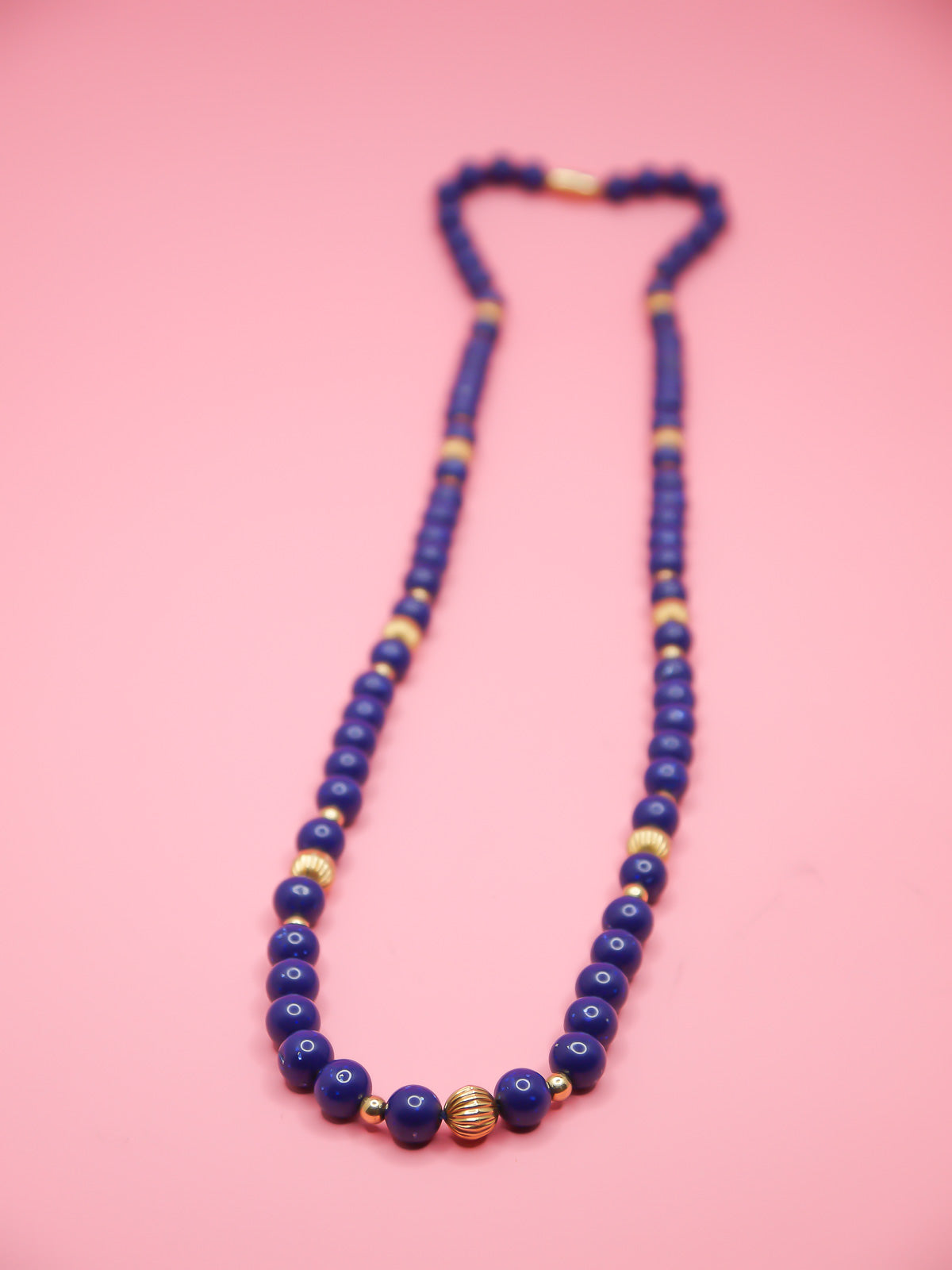 Vintage necklace with blue speckled beads and brass spacer beads with a brass clasp