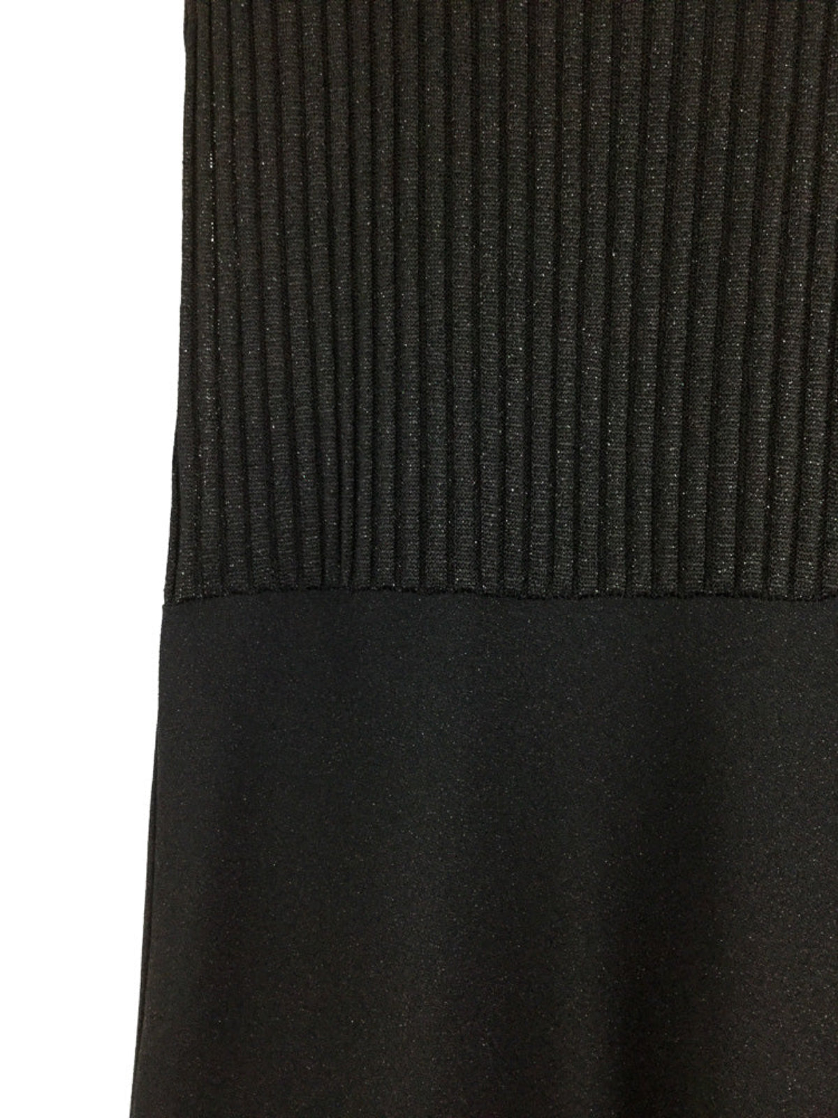Close-up of a black ribbed dress on a white background