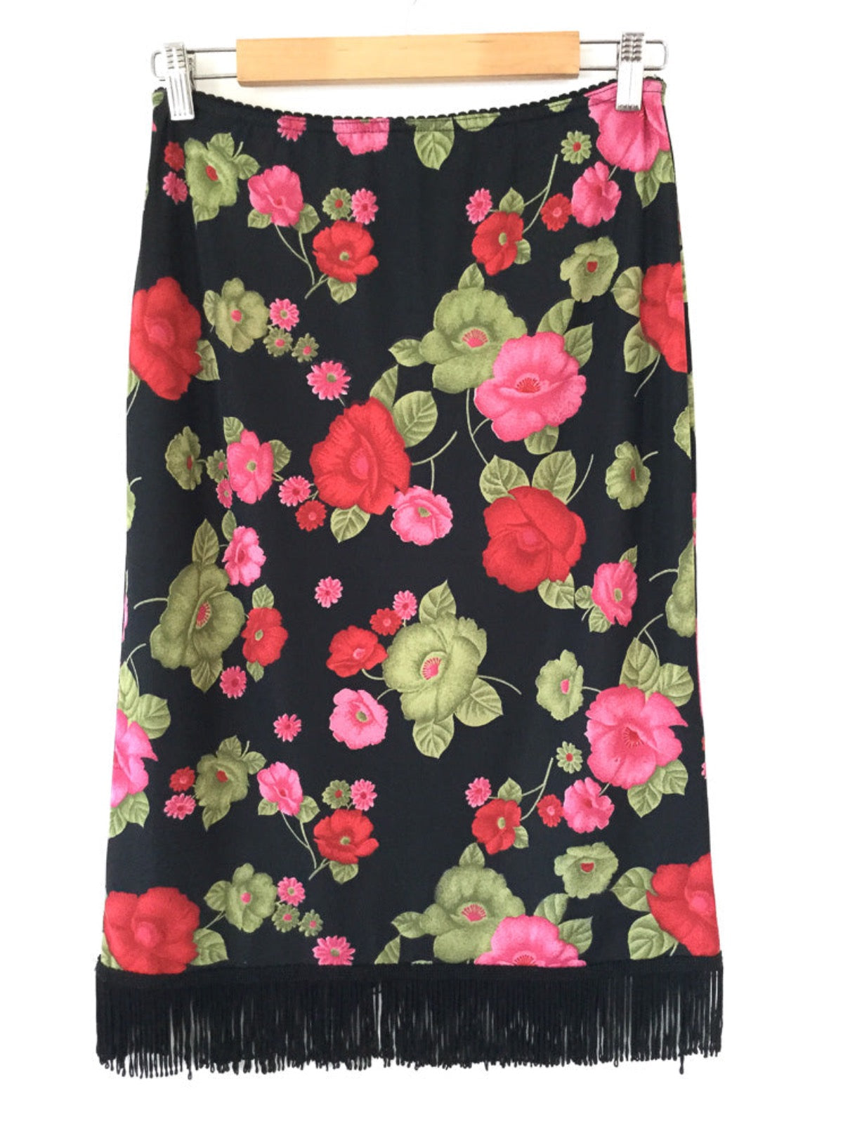 Vintage 90's floral print skirt with big bold flowers in pink, red & green on a black backdrop with an elastic waistband and black fringing on the hem