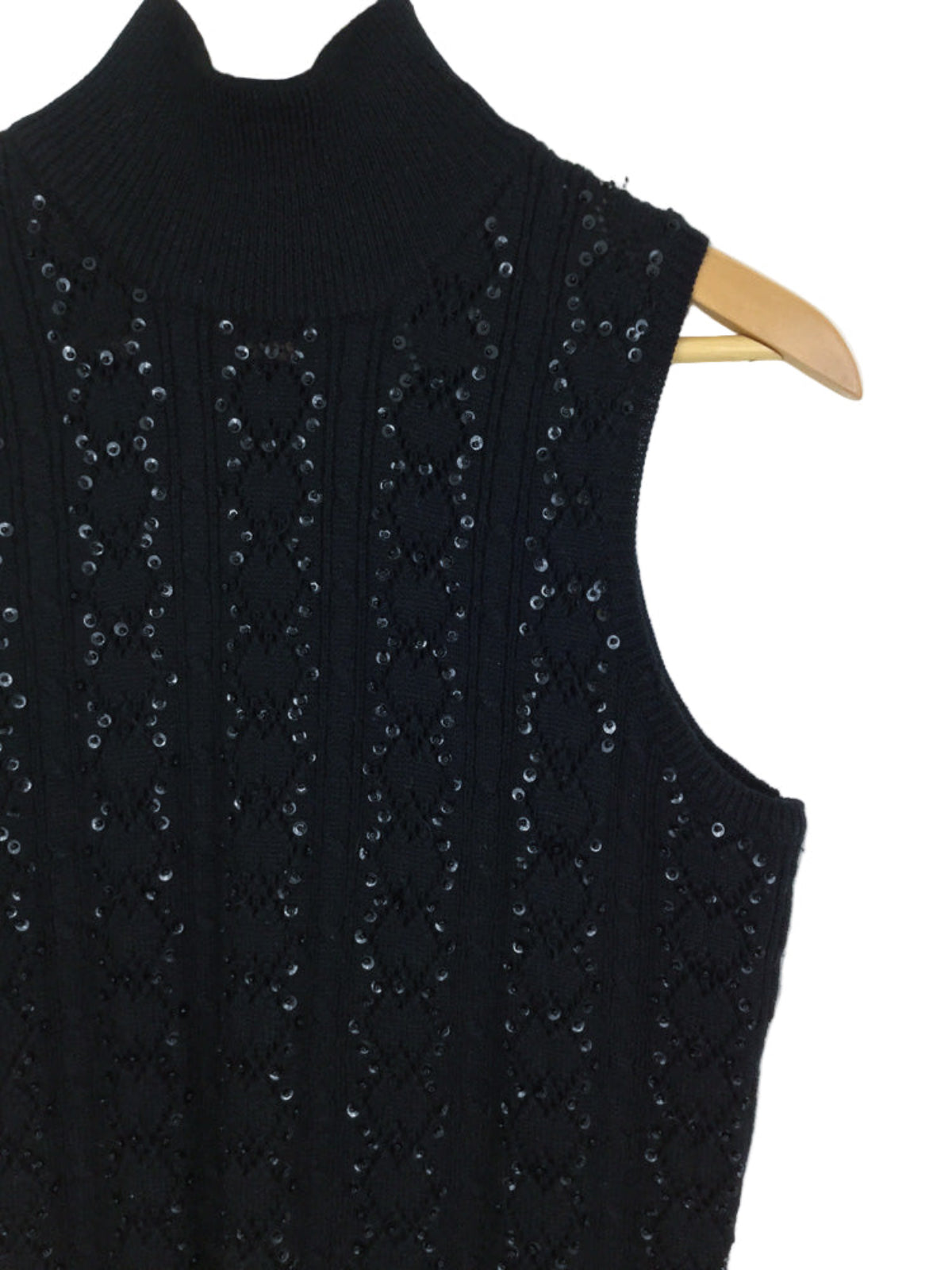 Black sleeveless knitted top with sequin details on a white background