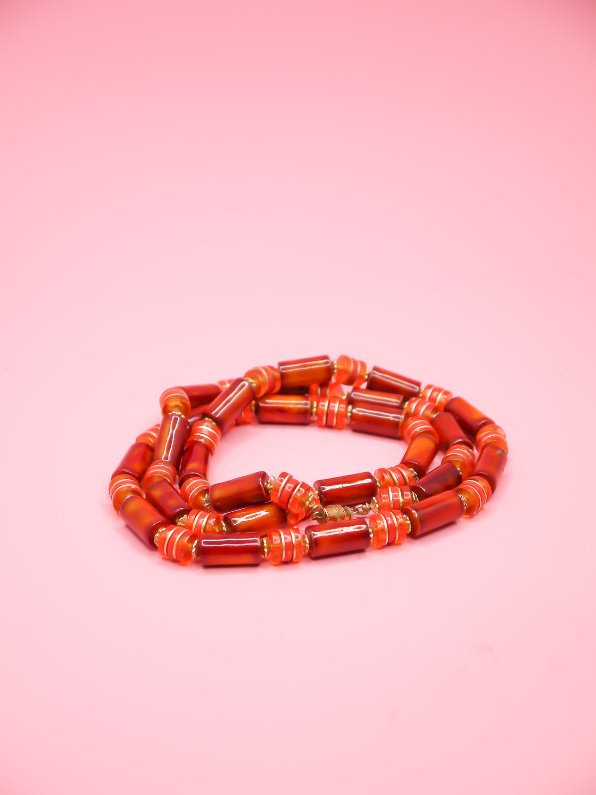 Orange & brown resin tube bead necklace with brass spacer beads and a brass clasp closure