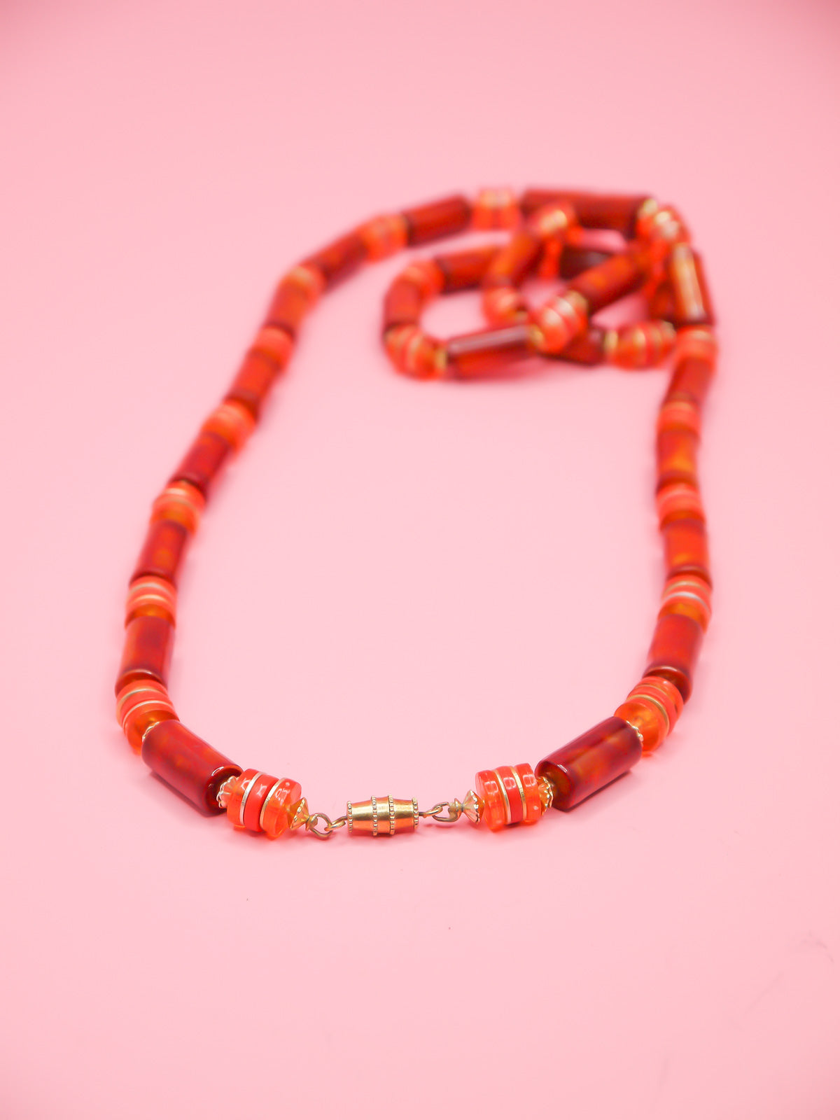 Orange & brown resin tube bead necklace with brass spacer beads and a brass clasp closure