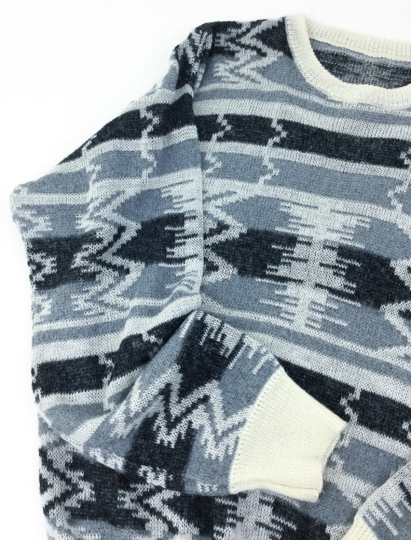 Grey and black aztec print unisex fine knit jumper with cream ribbed neckline, cuffs and hem