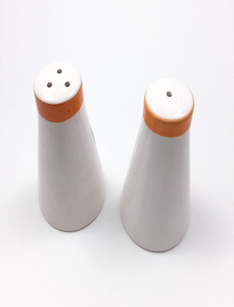 Vintage salt and pepper shakers Made in Japan with hand painted fruit on the front with an orange painted rim and rubber stopper underneath.