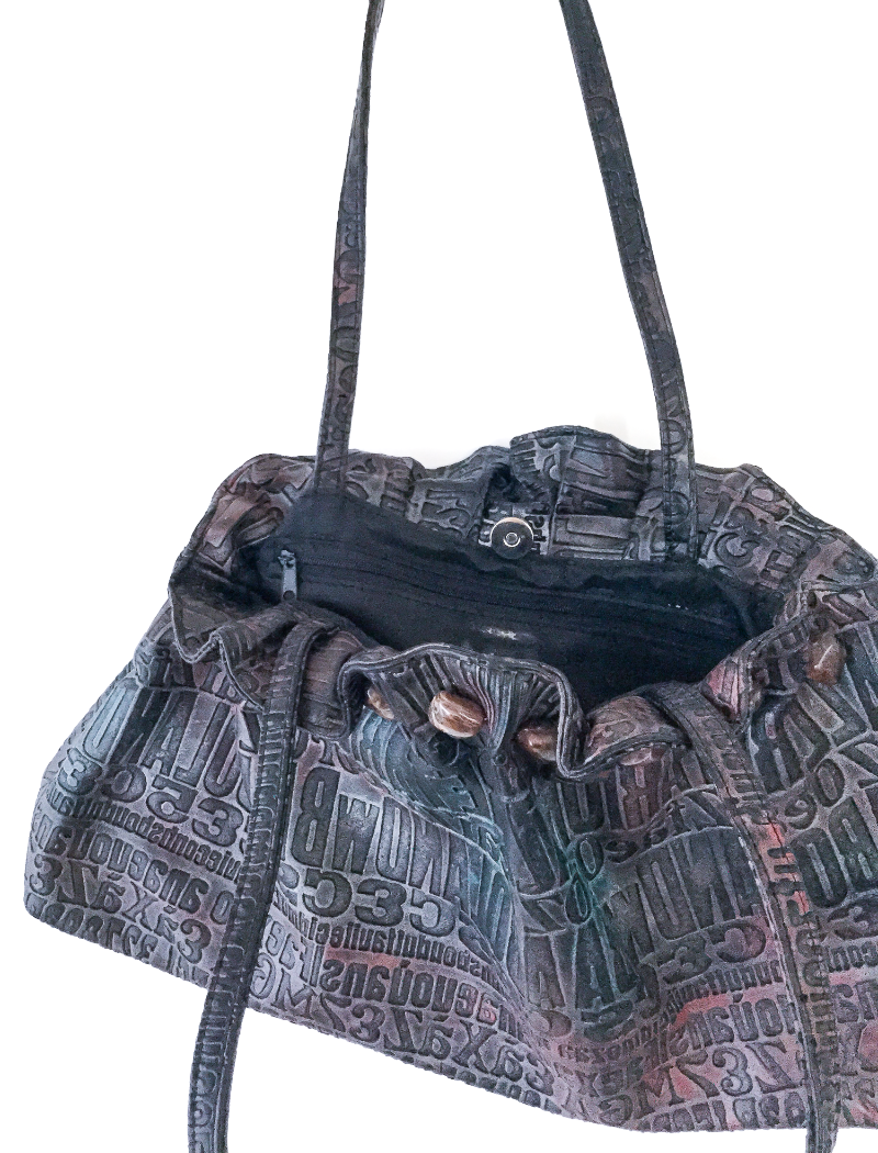 Metallic embossed typography bag with gemstone trim