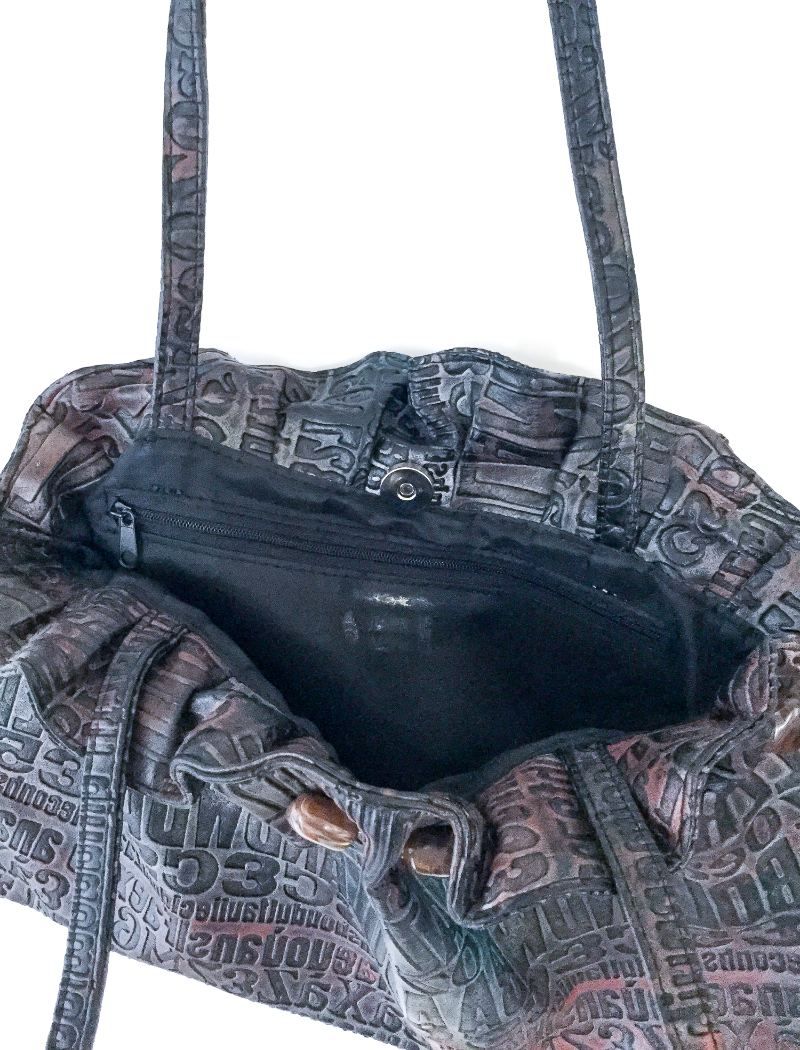 Metallic embossed typography bag with gemstone trim