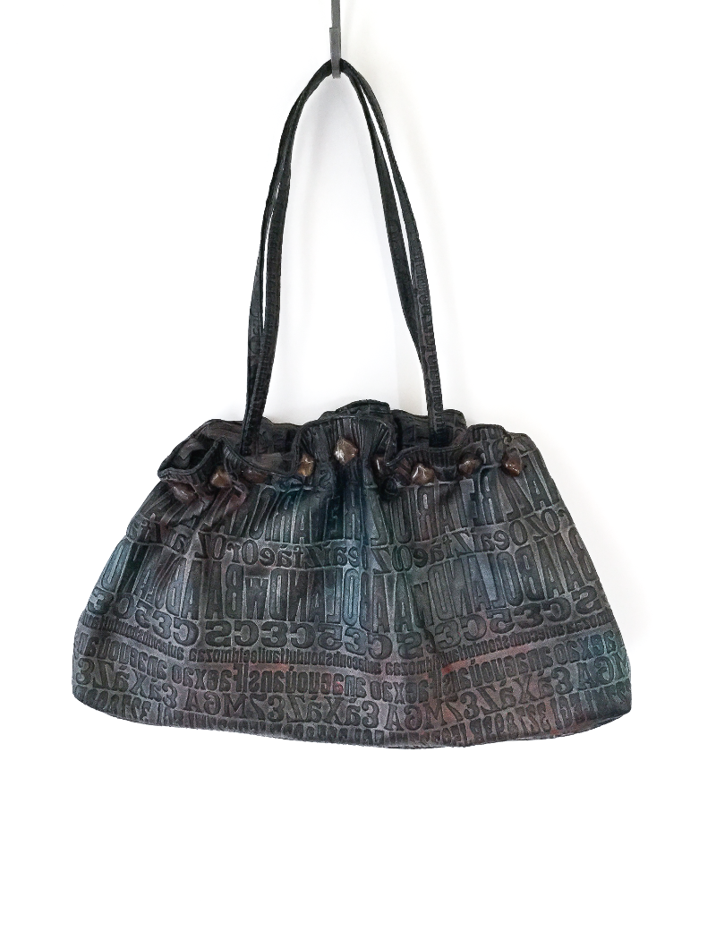 Metallic embossed typography bag with gemstone trim