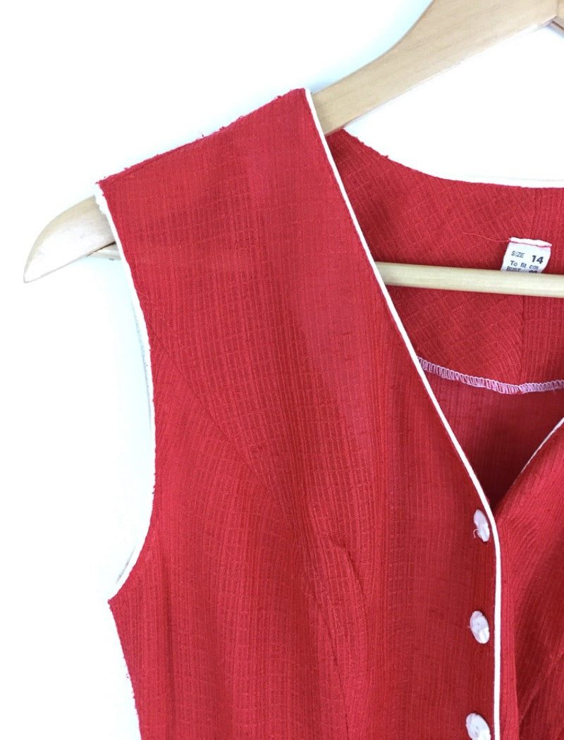 1970's red v-neck sleeveless sheer a-line dress with white piping around the arms and neckline with white buttons down the front